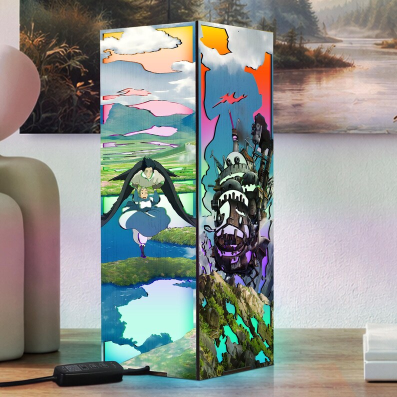 May include: A rectangular lamp featuring colorful anime-style artwork. The lamp's design includes images of characters and landscapes. The artwork is displayed on a light-up panel, creating a vibrant and decorative lighting fixture.