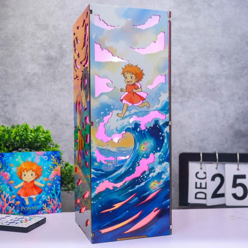 May include: A rectangular wooden lamp featuring a colorful illustration of a character with orange hair running across ocean waves. The design includes cut-out cloud shapes that emit a soft pink light, with dark edges and a vertical orientation.