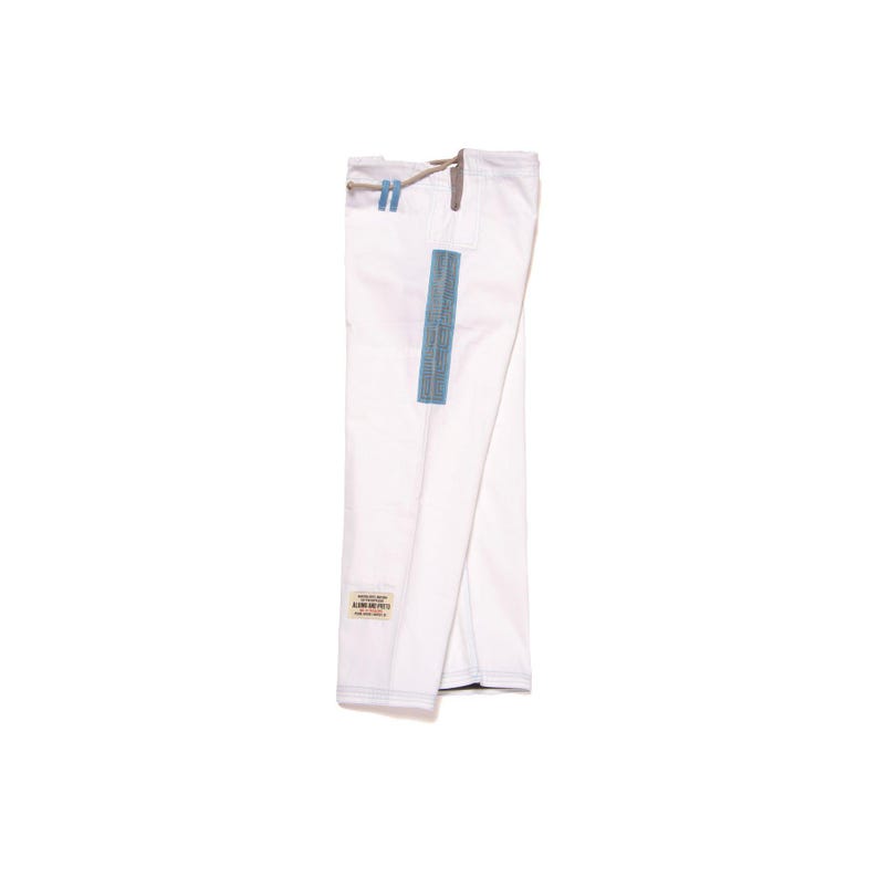 May include: A pair of white martial arts pants featuring a drawstring waist with light blue accents. A vertical blue rectangular patch is positioned on the side of the leg, and a small rectangular label with text is sewn near the bottom hem.