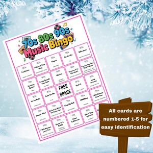 May include: A Music Bingo game card featuring songs from the 70s, 80s, and 90s, with a pink border. The card includes song titles and artist names. A wooden sign indicates that all cards are numbered 1-5 for easy identification.