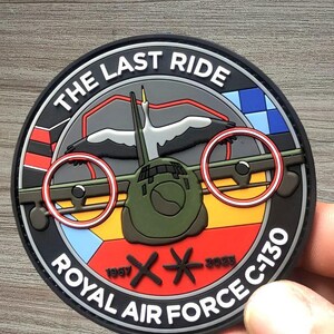 May include: Circular patch with the text "THE LAST RIDE" and "ROYAL AIR FORCE C-130". The patch features a stylized aircraft, a bird, and dates 1957 and 2023. The patch has a black border with red, yellow, and blue accents.