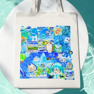 May include: A white canvas tote bag featuring a vibrant collage of blue-toned digital graphics, including a Windows-style interface, a cat, a cartoon character with teal hair, various aquatic elements, and the text 2000, all arranged in a dense composition.
