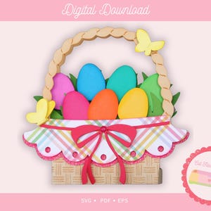May include: A digital download image of an Easter basket filled with colorful eggs and green leaves. The basket has a wooden handle and is decorated with butterflies and a plaid ribbon. The image includes the text "Digital Download".