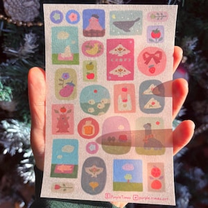 May include: A sheet of decorative stickers with a variety of colourful illustrations. The stickers depict mountains, birds, fruit, and other whimsical designs. The text "Purple Times" and "purple.times.art" is printed at the bottom.