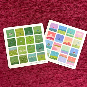 May include: Two square sticker sheets featuring a grid of sixteen small illustrations each. One sheet displays various green landscapes, while the other shows colorful scenes in pink, blue, and yellow. Both sheets include the text purple.times.art.