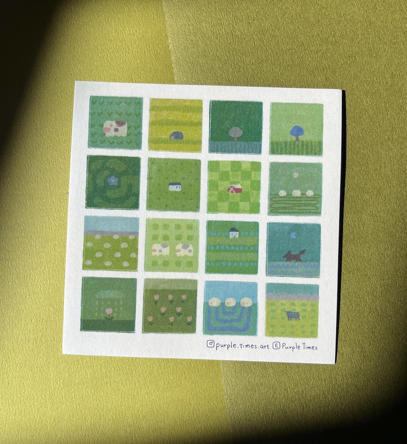 May include: A square art print featuring a grid of sixteen small illustrations in various shades of green, blue, and white. The scenes depict landscapes, animals, and plants. The text purple.times.art and Purple Times is printed at the bottom.