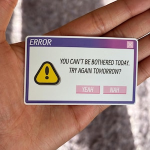 May include: A rectangular sticker with a purple and white gradient top, featuring the word "ERROR" and a yellow warning sign. The text reads "YOU CAN'T BE BOTHERED TODAY. TRY AGAIN TOMORROW?" with "YEAH" and "NAH" buttons.