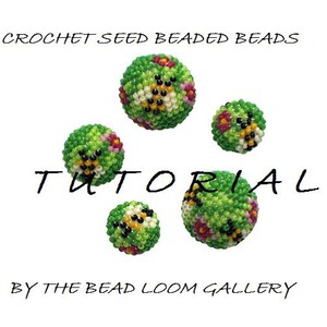 May include: A tutorial image featuring five crocheted seed beaded beads. The beads are primarily green with accents of pink, yellow, black, and white. Text on the image reads "CROCHET SEED BEADED BEADS TUTORIAL BY THE BEAD LOOM GALLERY."