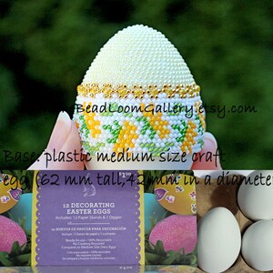 May include: A decorative Easter egg, 62 mm tall and 42 mm in diameter, with a beaded design. The top is covered in small white beads, with a gold band. The base features a pattern of yellow and green beads. The image also shows a box of decorating Easter eggs.