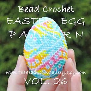 May include: A colourful beaded Easter egg crochet pattern, with a blue, white, pink, and yellow design. The egg is held in a hand and the text "Bead Crochet Easter Egg Pattern Vol. 26" is visible.