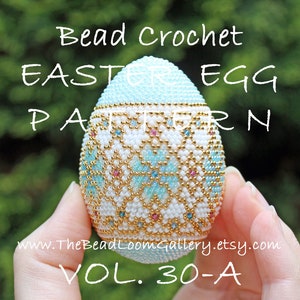 May include: A beaded crochet Easter egg pattern, featuring a white egg with a blue and gold geometric design. The egg is held in a hand, and the text "Bead Crochet Easter Egg Pattern Vol. 30-A" is visible below the egg.