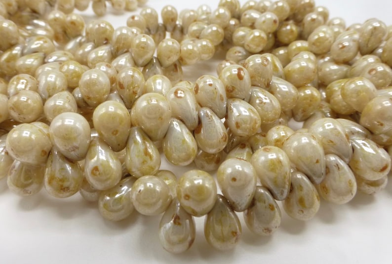 100 Czech Glass Tiny Tear Drop Beads in a Opaque Cream Luster with Picasso Finish Size 4x6mm