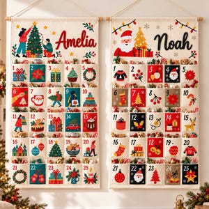 May include: Two rectangular fabric advent calendars hanging side by side, featuring twenty-five numbered pockets each. The left calendar displays the name Amelia, and the right calendar displays the name Noah, both decorated with festive holiday illustrations.
