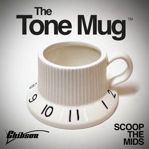 May include: White ceramic mug shaped like a guitar knob with numbers 6, 9, 10, 11, and 12 printed on the side. The mug is filled with a light brown liquid. The text "The Tone Mug" is printed above the mug. The text "Scoop The Mids" is printed below the mug.