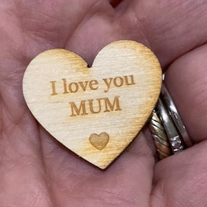 May include: Wooden heart-shaped ornament with the text "I love you MUM" engraved on it.