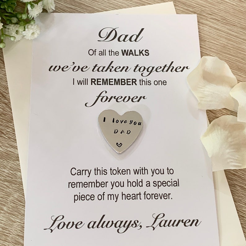 May include: A white card with a silver heart charm attached. The card reads "Dad, Of all the WALKS we've taken together I will REMEMBER this one forever. I love you DAD. Carry this token with you to remember you hold a special piece of my heart forever. Love always, Lauren."
