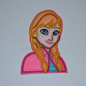 May include: Embroidered iron-on patch featuring a cartoon image of Anna from the movie Frozen. She has long blonde braids, blue eyes, and is wearing a pink dress with a blue bodice.