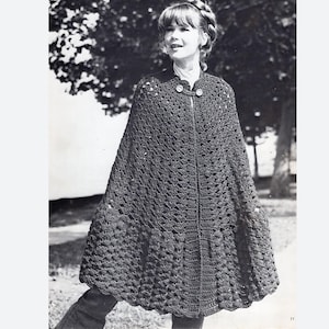 May include: A crochet cape with a button fastening. The cape is made from textured yarn and has a scalloped hem.