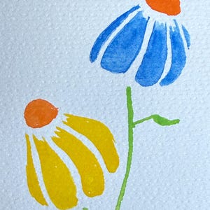 May include: A watercolor painting on textured white paper featuring two stylized flowers. One flower has blue petals and an orange center, while the other has yellow petals and an orange center. Both flowers have thin green stems.