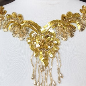 Cute  beaded and   embroidered  applique with  sequence  gold color   1 pieces listing 13 1/2 inches wide at the neck