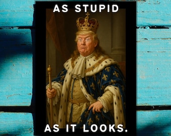 May include: A framed print featuring a portrait of a man wearing a crown and royal attire. The text "AS STUPID AS IT LOOKS" is printed in white at the top and bottom of the image. The background is a distressed, turquoise-colored wooden surface.