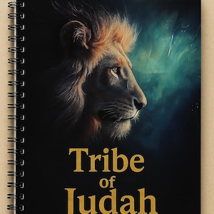 May include: Spiral-bound notebook featuring a majestic lion's profile with a golden mane against a dark, textured background. The words "Tribe of Judah" are displayed in gold lettering. The notebook has a black cover.