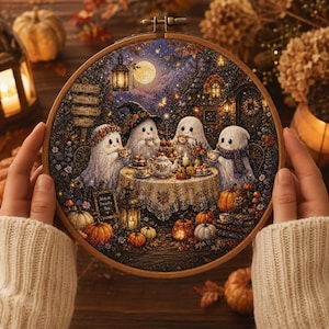 May include: A circular embroidery hoop containing a detailed cross-stitch scene of four white ghosts having a tea party at a table outdoors at night. The scene includes a full moon, lanterns, pumpkins, and a signpost with text reading Pumpkin Park.