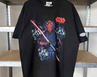 May include: Black t-shirt with a graphic print of Darth Maul from Star Wars Episode I. The graphic shows Darth Maul holding a double-bladed lightsaber with a red blade.