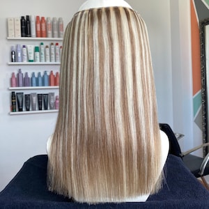 May include: A white ceramic mug with a black handle and the text "But First, Coffee" in a black, bold font. The mug is on a white surface.