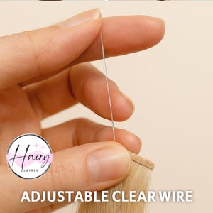 May include: A close-up of a hand holding a thin, clear wire. The wire is positioned above a section of blonde hair extensions. The text "ADJUSTABLE CLEAR WIRE" is displayed at the bottom of the image.