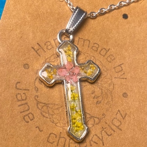 Cross necklace with real flowers.