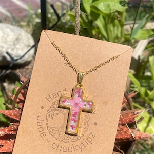 Cross necklace with real flowers.