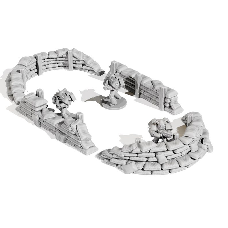 May include: A miniature war game terrain set featuring gray sandbag walls and three miniature figures. The sandbag walls are arranged in curved and straight sections. The figures are in a battle stance, suggesting a war game theme.