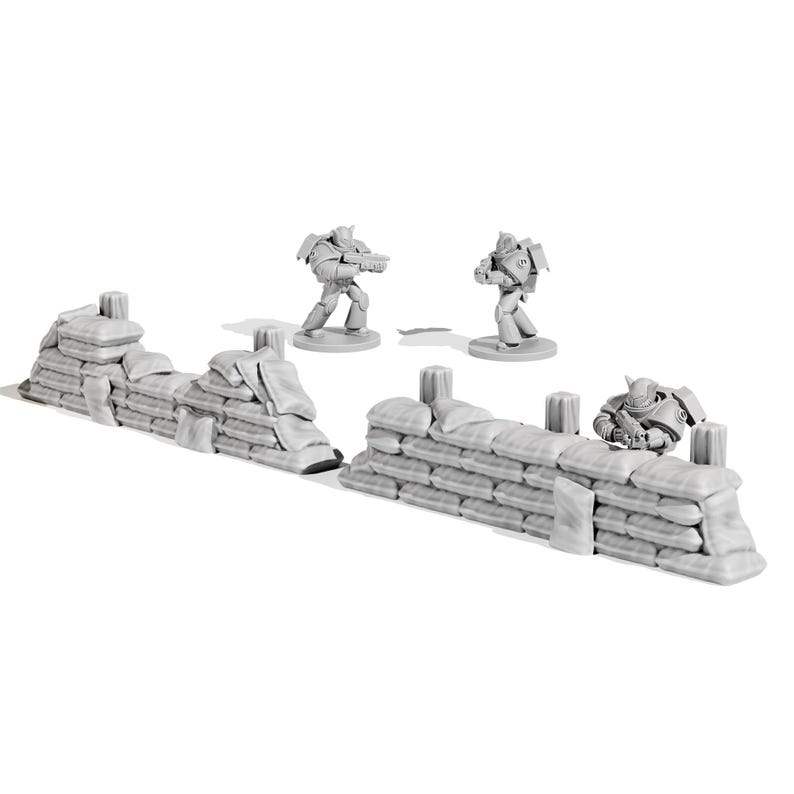 May include: A miniature war game scene featuring two sandbag walls and three futuristic soldier figurines. The sandbag walls are light gray, and the soldiers are in a similar color. The scene is set against a white background.
