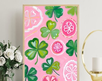 May include: A framed print with a pink background and a pattern of green four-leaf clovers and pink and white circles.