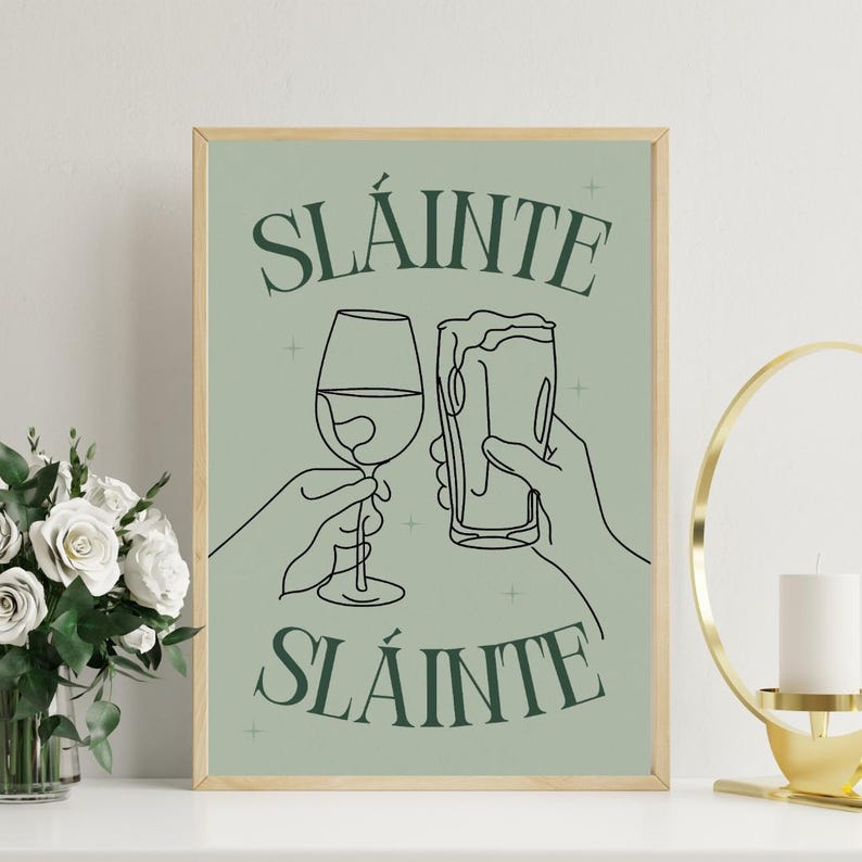 May include: A framed green poster with a white background and black line drawings of two glasses clinking. The text on the poster reads 'Sláinte Sláinte'. Sláinte Guinness Pint Art Print Beer Feminine Stout Wine Glass Green, Digital Download, Modern Bar Decor, Cute Wall Art, Irish Ireland Art