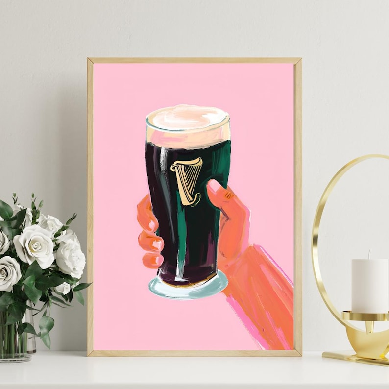 May include: A pink background with a glass of dark beer with a white head. The beer has a green and black design with a gold harp logo. The beer is in a hand with a pink and orange color. Guinness Pint Art Print Beer Feminine Stout in Pink - Digital Download, Modern Bar Decor, Cute Pub Wall Art, Irish Ireland Fun Art Guinness Pint Art Print Beer Feminine Stout in Pink - Digital Download, Modern Bar Decor, Cute Pub Wall Art, Irish Ireland Fun Art
