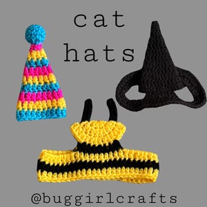 May include: Three crocheted cat hats in the image. One is a party hat with blue, pink, yellow, and blue stripes. Another is a black cat mask. The third is a yellow and black bee costume. The text "cat hats" is above the hats.