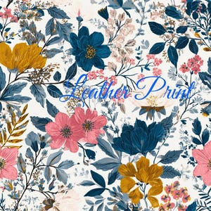 May include: A white fabric featuring a dense floral pattern with mustard yellow, deep blue, and soft pink flowers interspersed with dark blue foliage and stems. The text "Leather Print" is written in blue cursive script across the center.