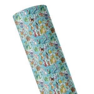 May include: A roll of light blue fabric featuring a repeating pattern of various colorful cartoon characters, including dragons, small blue creatures, and other animated figures scattered across the surface in a dense, multi-directional arrangement.