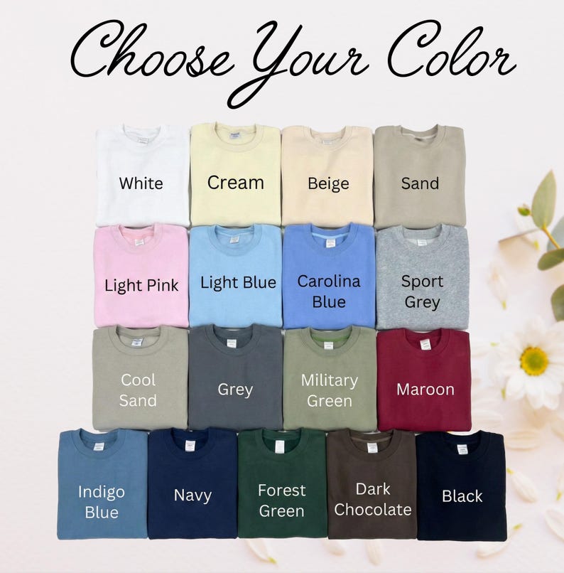 May include: A collection of fifteen crewneck sweatshirts arranged in a grid, each labeled with its color: White, Cream, Beige, Sand, Light Pink, Light Blue, Carolina Blue, Sport Grey, Cool Sand, Grey, Military Green, Maroon, Indigo Blue, Navy, Forest Green, Dark Chocolate, and Black. The text 'Choose Your Color' is at the top.