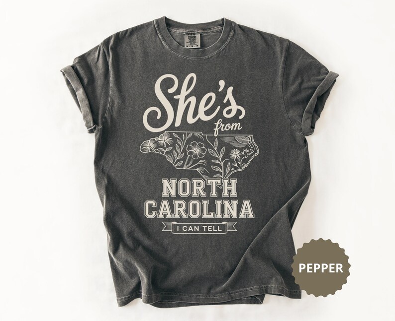 She's from North Carolina t-shirt with floral outline of the state.