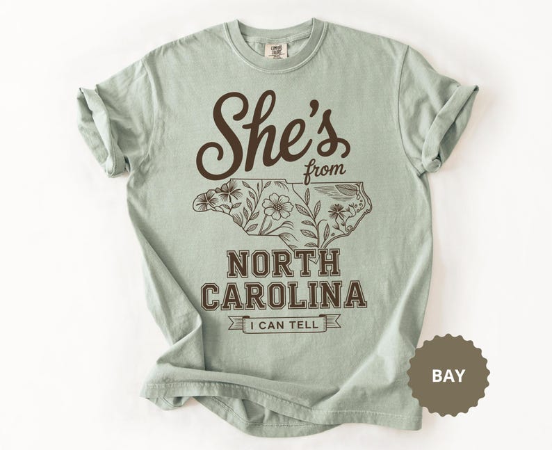 She's from North Carolina t-shirt with floral outline of the state.