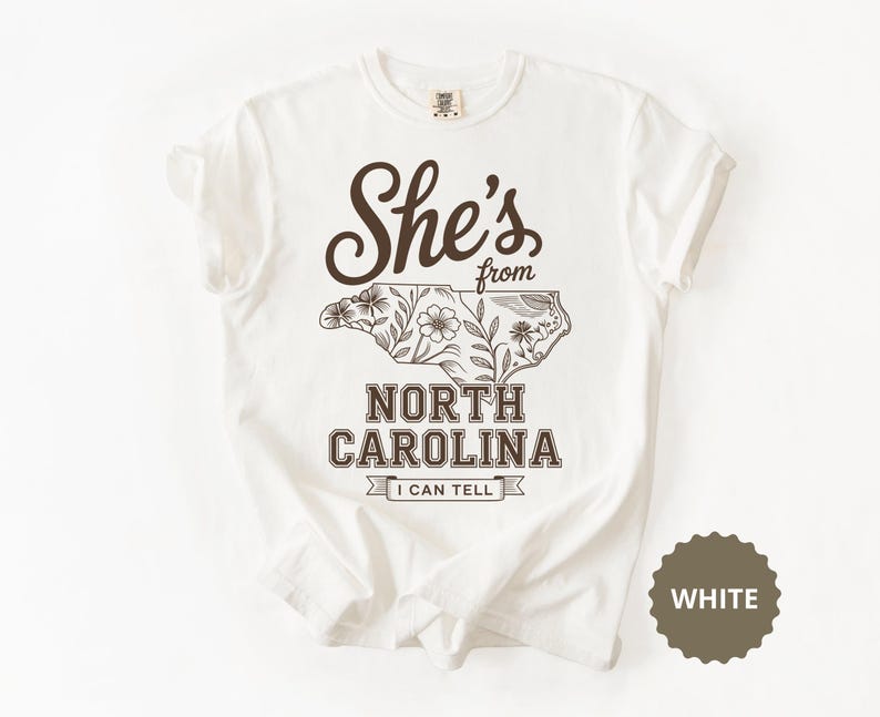 White t-shirt with "She's from North Carolina I Can Tell" and floral map.