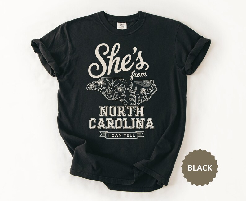 Black t-shirt with "She's from North Carolina" and floral map.
