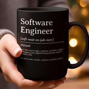 Black mug with "Software Engineer" definition and related terms.
