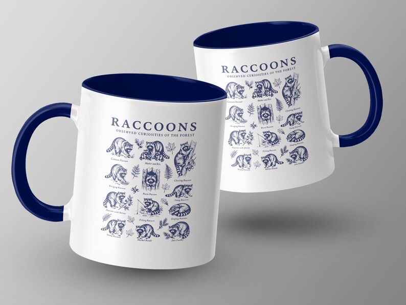 Two white mugs with navy handles feature a repeating dark blue raccoon illustration and text.