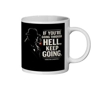 May include: A white ceramic mug with a black handle and the text "But First, Coffee" in a bold, black font. The mug is set against a blurred background, suggesting a cosy setting.