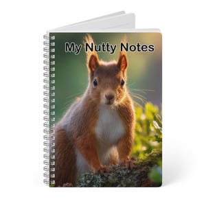 May include: A spiral-bound notebook with the text "My Nutty Notes" on the cover. The cover features a close-up image of a red squirrel with a white chest, set against a blurred green background. The notebook is white.
