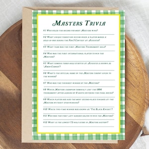 May include: A green and white chequered card with yellow text. The card features a Masters Trivia game with 12 questions about the Masters golf tournament.